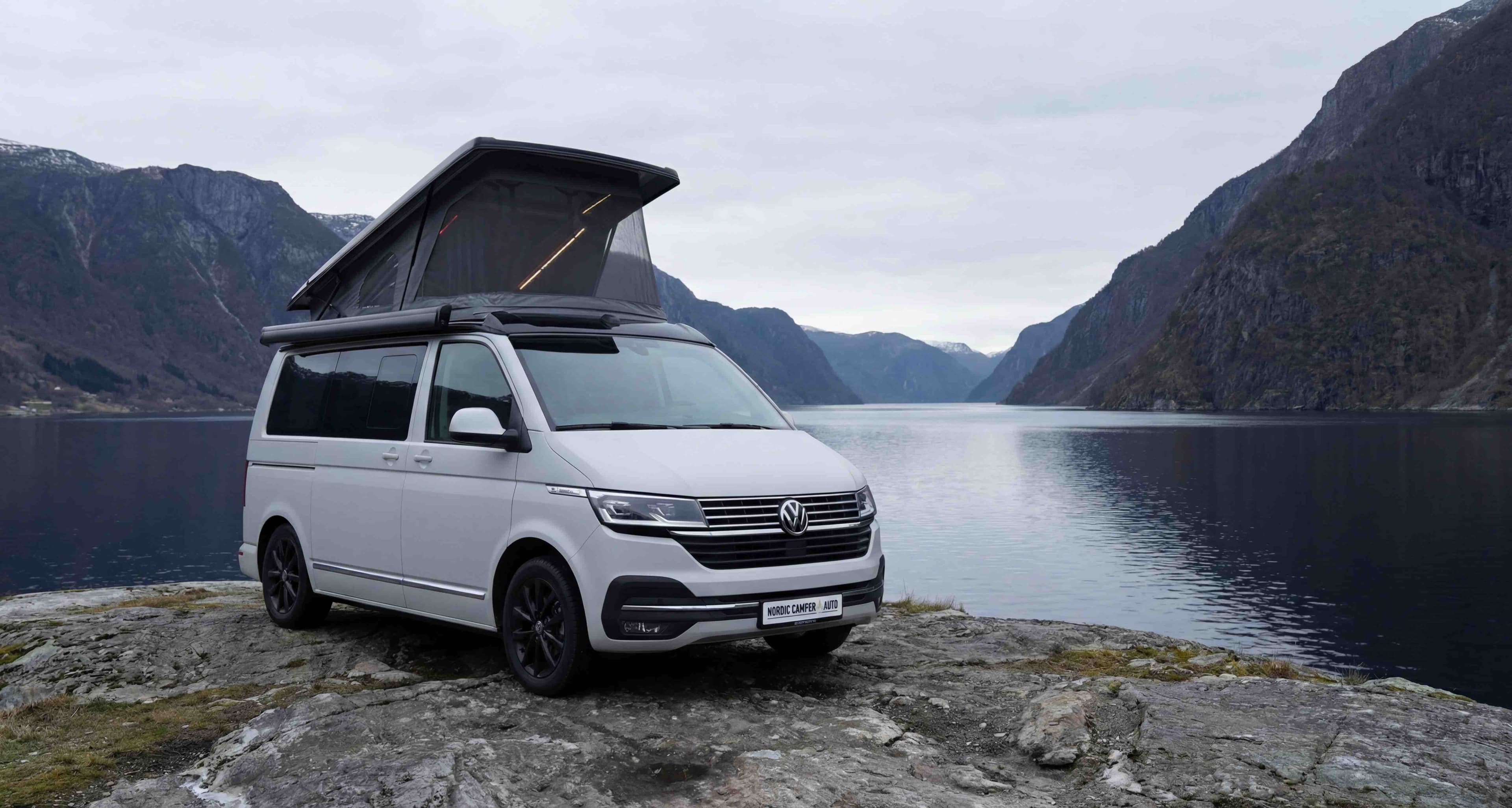 Custom camper van conversion by Nordic Camper & Auto parked by a Norwegian fjord
